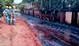 Workers look on bemused by the river of caramel in Santa Adelia